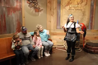 family interacting with bird at Animal Encounter