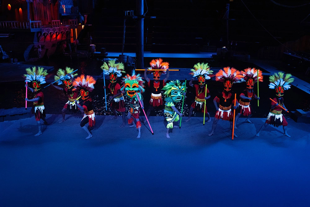 colorful masks and dancers at Pirates Voyage